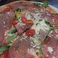 Parma Pizza · Tomato, mozzarella, arugula, prosciutto, grape tomato and shaved Parmigiano.