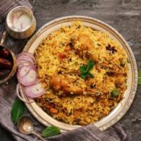 Chicken Biryani · Chicken marinated with Indian spices cooked with basmati rice in slow fire.