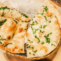 Garlic Naan · White flour bread baked in tandoor with garlic topping.