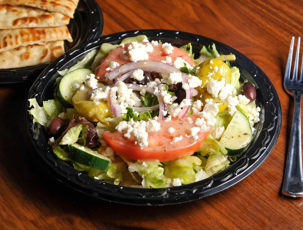Grecian Salad · Lettuce, tomatoes, onions, cucumbers, Kalamata olives, pepperoncini and feta. Served with grilled pita.