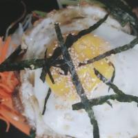 Dolsot Bibimbap · Served in a hot stone pot. Assorted vegetables over rice with an egg.