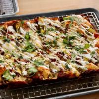 Carnitas Taco Special Pizza · Crema drizzle, cheese blend, onions, jalapenos, shredded pork, and cilantro.