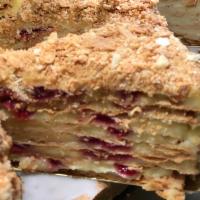 Napoleon cake with raspberries slice · Slice of famous Napoleon cake made with layers of dough filled with a custard cream and rasp...