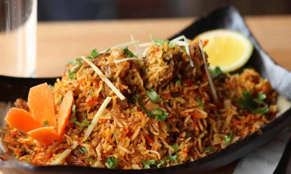 Chicken Biryani · Boneless Chicken Cooked With Saffron flavor Basmati Rice in herbs And Spices, And Topped With Nuts And Raisins. Served With Raita
