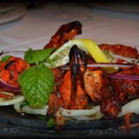 Tandoori Chicken · Chicken marinated overnight in yogurt and freshly ground spices, barbecued in a clay oven.