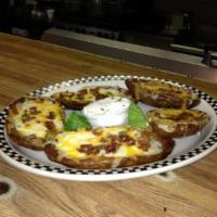 Stuffed Potato Skins · Topped with cheddar, bacon and chives and served with sour cream. 