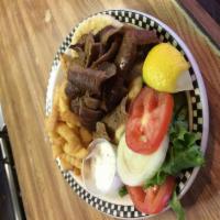 Famous Gyros · Off the cone served on a pita bread with cucumber sauce, onions and tomatoes. Served with ch...