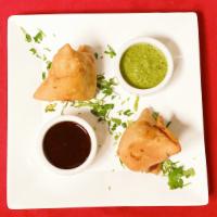 Vegetable Samosa · 2 triangular cnspy shell slutted with spiced potatoes, peas, carianda and served with chutney.