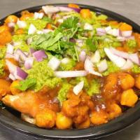 Chaat Samosa · Triangular crispy potato patty served with garbanzo curry, topping with chutney and onion.