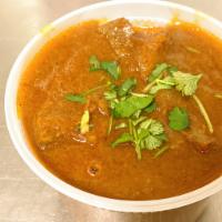 Punjabi Goat Curry  · Slow cooked goat with ginger, garlic, onion, & spices 