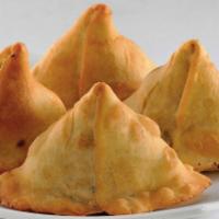Samosa · Crispy puffs filled with potatoes and green peas.