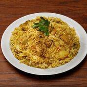 Chicken Biryani · Chicken cooked with spices and tomatoes, layered in basmati rice.