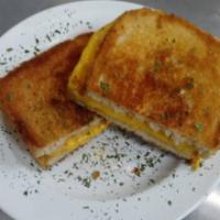 Grilled Cheese Sandwich · Two slices of Kraft yellow American cheese grilled between two white slices of buttery white...