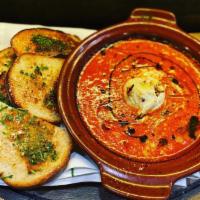 Baked Goat Cheese · Baked goat cheese in our delicious tomato basil sauce served with a side of crustini with an...