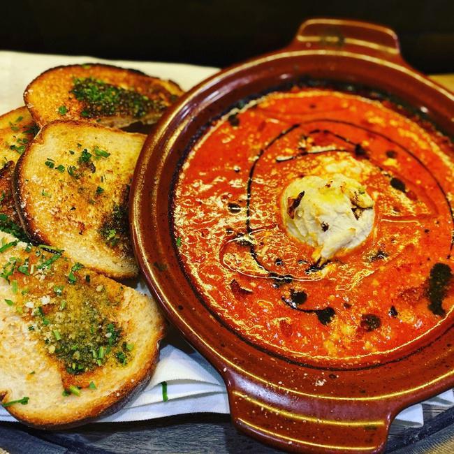 Baked Goat Cheese · Baked goat cheese in our delicious tomato basil sauce served with a side of crustini with an olive spread