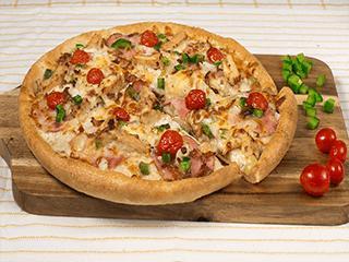 Ranch Style Chicken Pizza · Sarpino's traditional pan pizza baked to perfection and topped with creamy Ranch, tender grilled chicken strips, Canadian and smoked bacon, ripe tomatoes, sauteed green peppers and onions, our signature gourmet cheese blend and sharp Parmesan cheese.