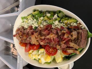 Cobb Salad · Hard boiled egg, chicken, avocados, tomato, bacon and blue cheese, romaine and ranch dressing.