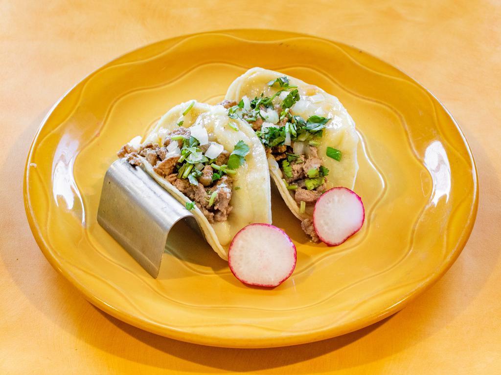 Quesa Tacos · 2 corn tortillas filled with Monterey jack cheese in the middle with your choice of meat on top with all toppings.
