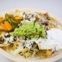 Super Nachos · Choice of meat with beans, cheese, sour cream, guacamole and jalapenos. 