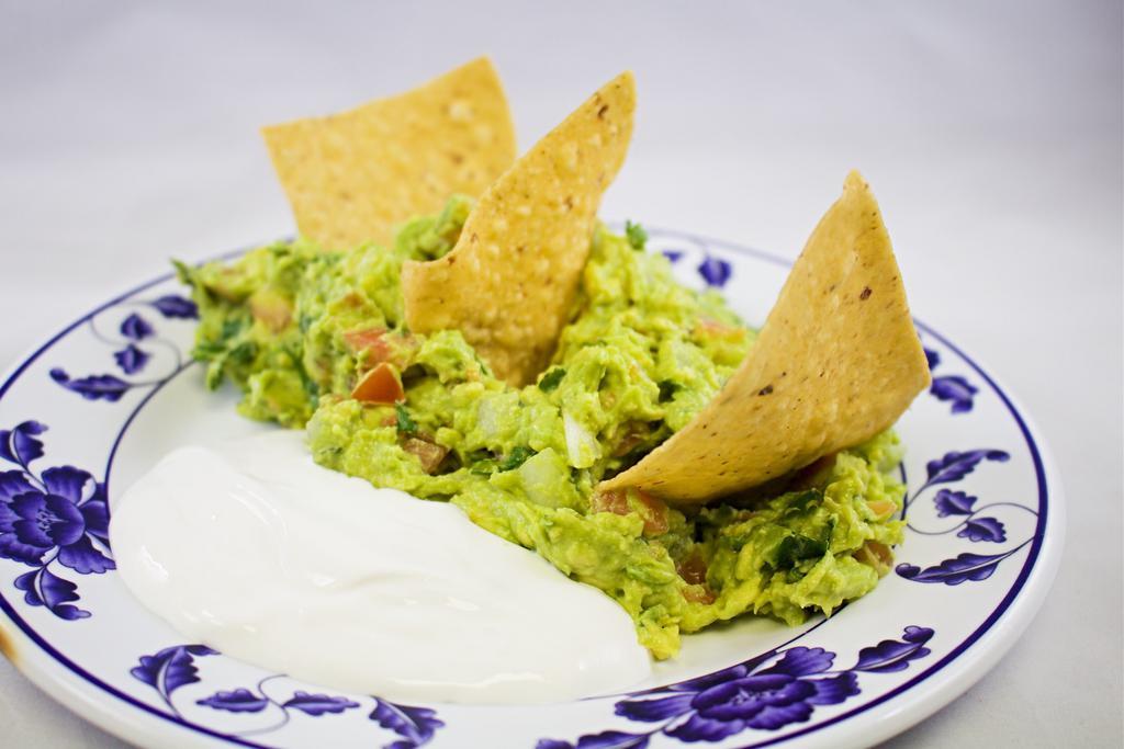 Guacamole with Chips · Avocado dip with chips.