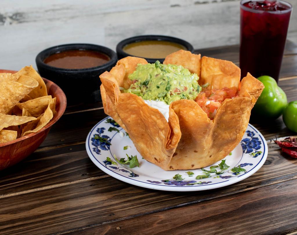 Taco Salad · Served with lettuce, tomato, cheese, beans, guacamole and sour cream. Choice of chicken, steak, ground beef, pork or vegetarian.