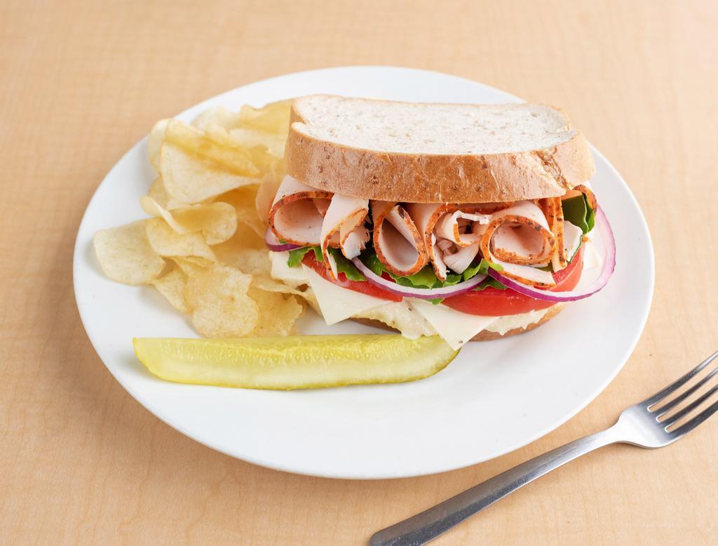 5. Turkey Sandwich · Served with white American cheese and topped with Sorella's Parmesan mayo. Made with Boar's Head meats and cheeses. Includes romaine lettuce, tomatoes and red onions. Served with chips.