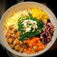 Bowl · Brown rice topped with red and green cabbage, pinto beans, corn, cheese, tomato, avocado, an...