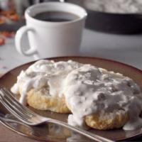 Gravy Biscuit Combo · Our fluffy buttermilk biscuit served open faced and topped with our creamy Cajun sausage gra...