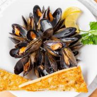 Mussels · Lemon, garlic, white wine sauce, and garlic bread.