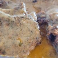 Smothered Pork Chop Meal · 2 pc Smothered Pork Loin Chops seasoned with house blend and oven baked then slow simmered i...