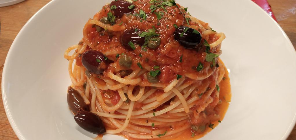 Spaghetti Puttanesca · Garlic, anchovies, capers, black olives, pepperoncino, and tomato sauce.