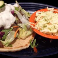 Grecian Gyros · Beef and lamb on a Greek pita with onions, tomatoes, lettuce and tzatziki sauce. Served with...