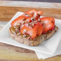Almond Strawberry Toast · Sprouted organic bread, organic almond butter, strawberry, pecans and honey.