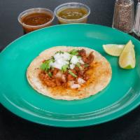 Al Pastor Taco · Pork and onions.