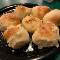 Garlic Knots · 
A classic snack, our garlic knots are strips of pizza dough tied in a knot, baked & then to...