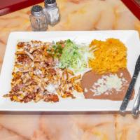 Chori Pollo Specialty · Marinated and grilled chicken strips cooked with chorizo topped with cheese sauce, served wi...