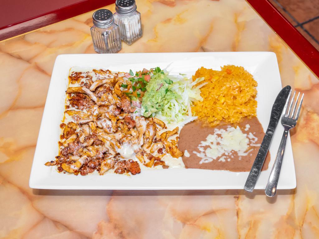 Chori Pollo Specialty · Marinated and grilled chicken strips cooked with chorizo topped with cheese sauce, served with rice,lettuce, cheese, guacamole, pico de gallo and tortillas.