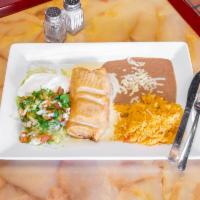 Classic Chimichanga · Four tortillas stuffed with ground beef or pulled chicken and fried to golden brown. Topped ...