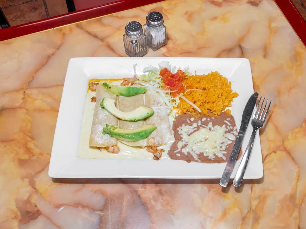 Seafood · 2 flour tortillas stuffed with shrimp, crab, pico de gallo, topped with spinach sauce, sour cream and avocado slices. Served with beans and rice.