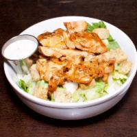Grilled Buffalo Chicken Salad · Tossed in our house wing sauce with crisp romaine lettuce, croutons, chopped celery and onio...