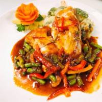 Salmon Prik Kingh · Grilled fillet salmon bedded with steam broccoli, green bean topped with chilli paste sauce.