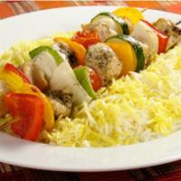 The Chicken Kabob Plate · Fresh chicken kabob sizzling over bed of rice, with side of salad, hummus and pita bread.