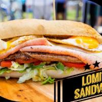 Lomito Sandwich Combo · A thinly sliced churrasc steak grilled topped with mozzarella cheese, ham, grilled egg, baco...