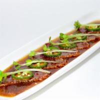 Cajun Tuna (6pcs) · Cajun seasoned tuna seared and topped with roasted garlic, jalapeño slices, radish hoots, yu...