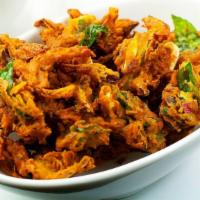 Onion Pakoda · A crispy south indian snack comprising of onions dipped in a flour, curry leaves, spices, an...