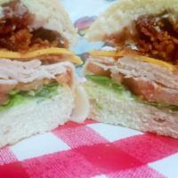 Crazy Club Sandwich · Loaded with hickory smoked bacon, turkey breast, Wisconsin cheddar, lettuce, tomato, & mayo.