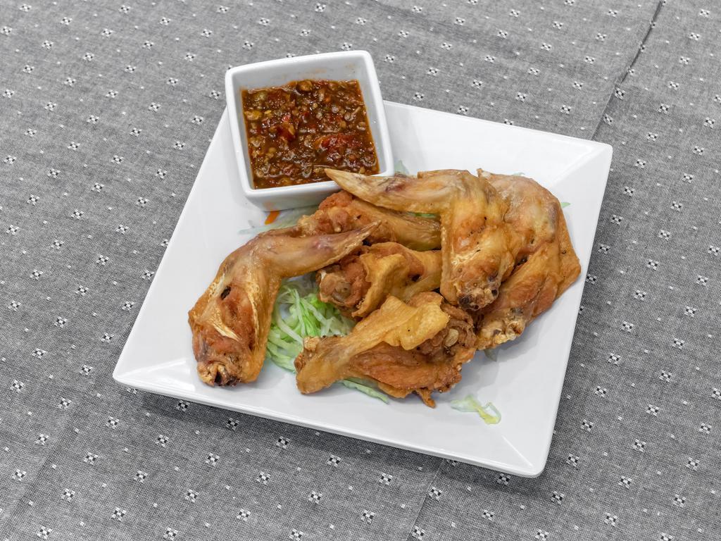A5. Fried Chicken Wings · 6 pieces. Seasoned, deep-fried wings with sweet and sour sauce or chili sauce. Please add in description if you want spicy chili sauce or sweet sauce.