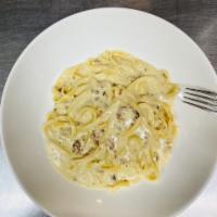 Fettuccine Carbonara · Tossed fettuccine pasta with bacon, onion and eggs in alfredo cream sauce