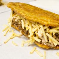 Patacon Mixto · Green plantain, shredded beef and shredded chicken, cheese, homemade sauce and potato steak....
