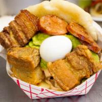 Arepa la Poderosa · Fried chicken and beef, cheese, pink sauce, fried pork bellies, chorizo and quail eggs.